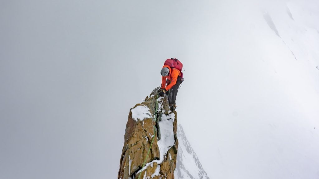 Man summiting a frosty peak