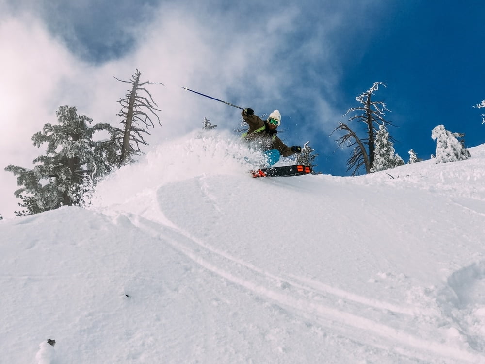  A skier doing a bank turn in deep powder at Sugar Bowl, a ski resort that gets the most snow in California