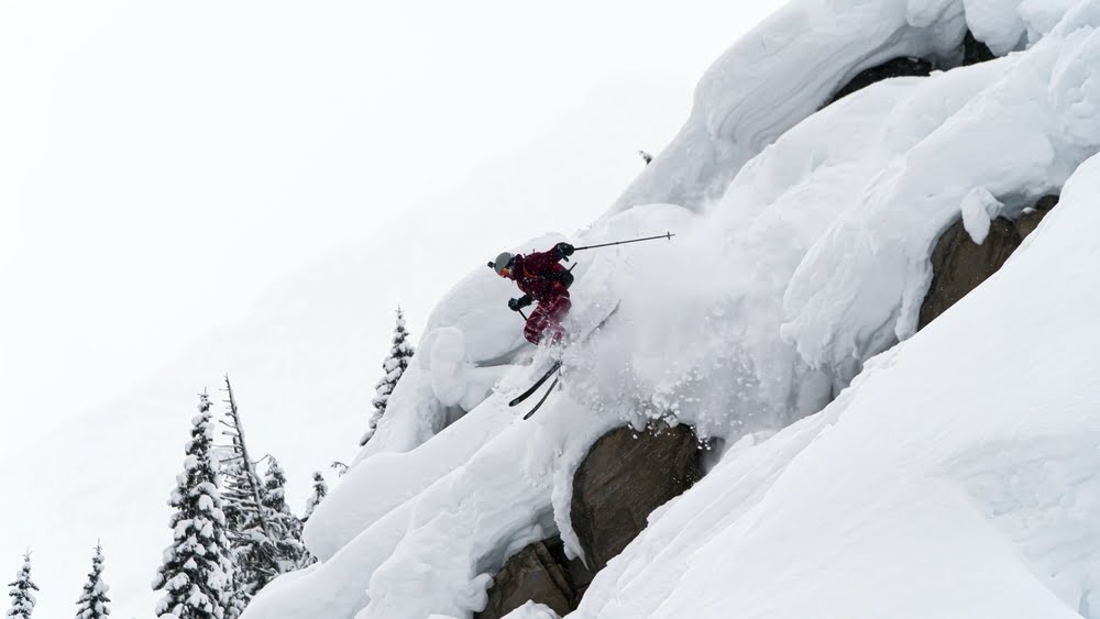 Skier riding in powder at the ski resort with the most snow in British Columbia 