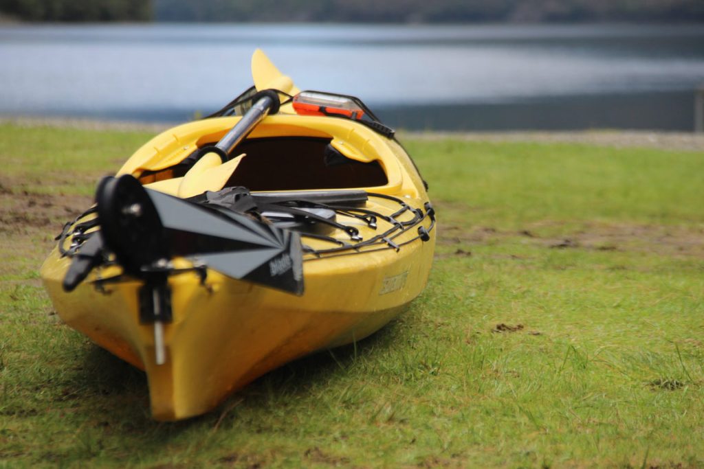 yellow kayak ready to be launched next to lake