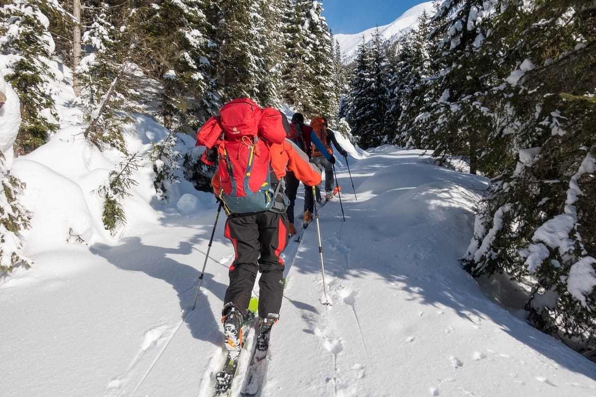 skiers-walking-uphill