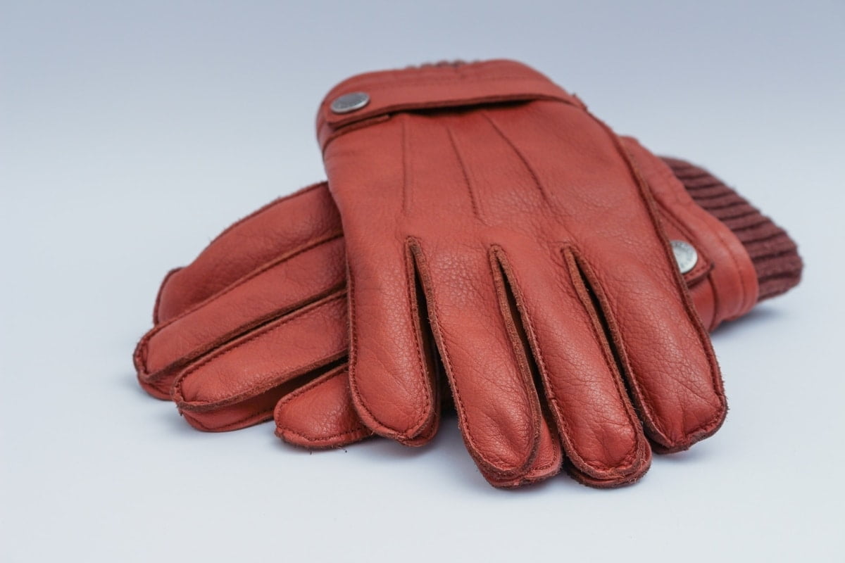 Pair of rust colored leather gloves.