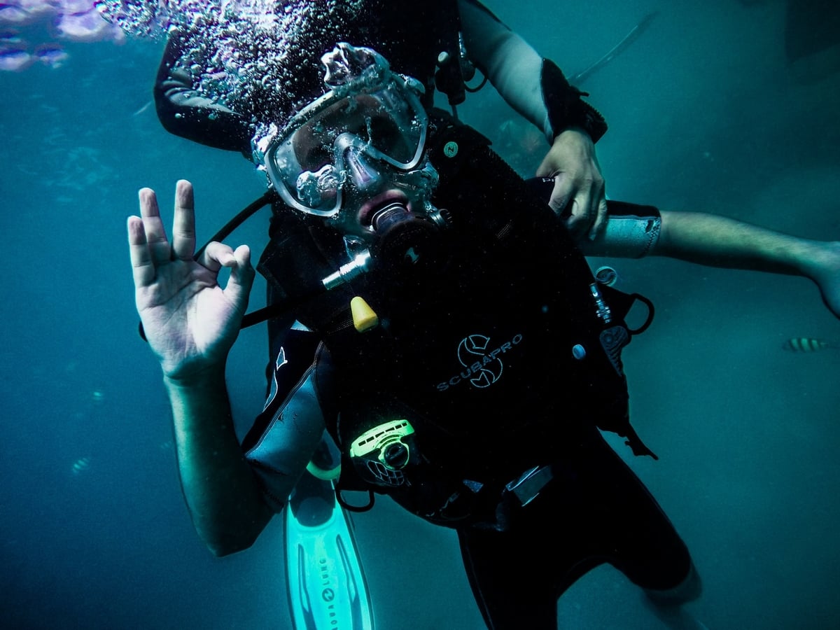 Scuba diver underwater showing ok sign