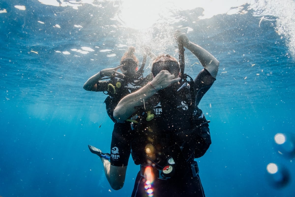 Two scuba divers ascending to the surface